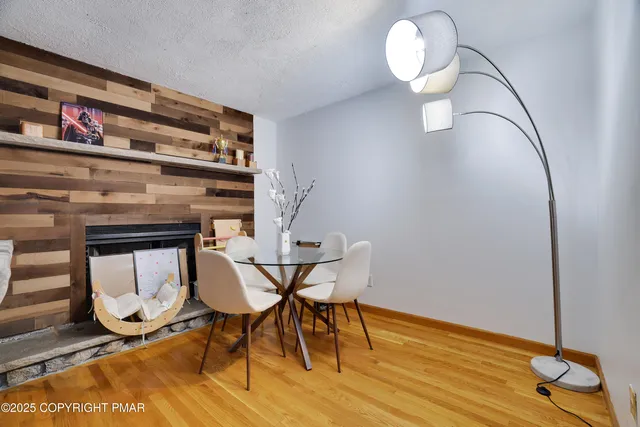 a view of a room with wooden floor and furniture