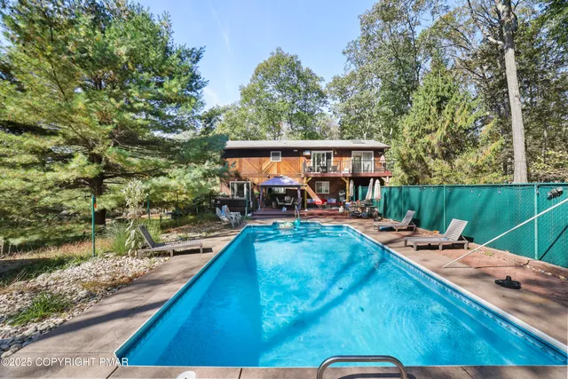 swimming pool view with a seating space