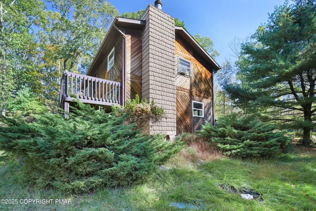 a view of a patio with table and chairs potted plants and large tree