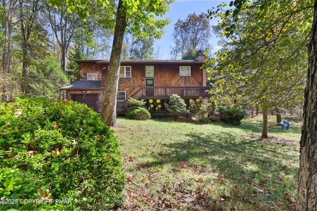 a view of a house with a yard and plants