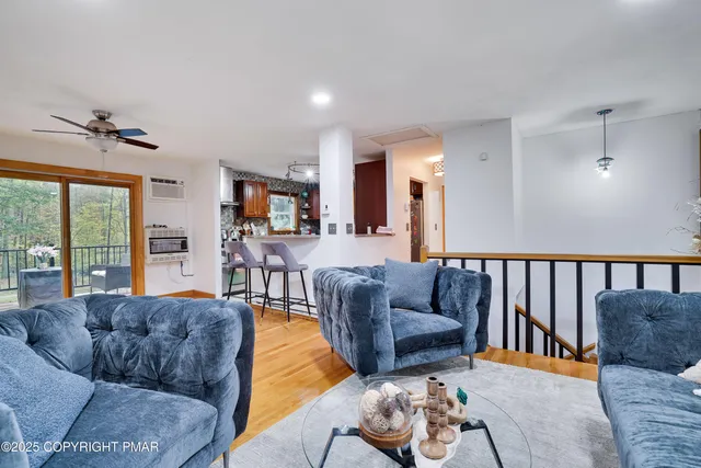 a living room with furniture fireplace and a large window