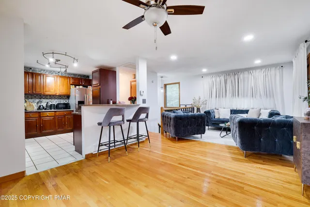 a living room with stainless steel appliances kitchen island granite countertop furniture and a kitchen view
