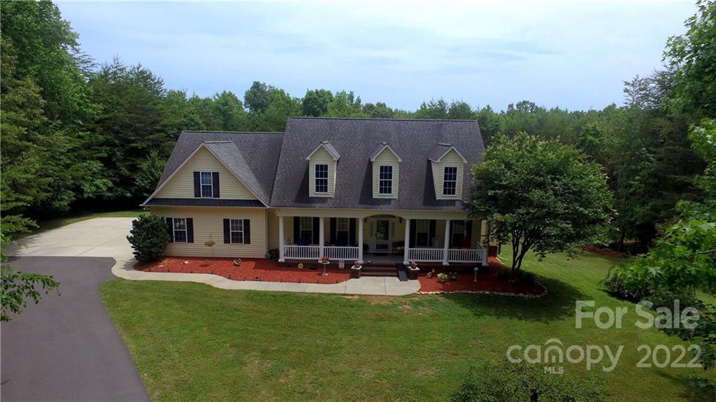 765 Bridle Path Farm Road Cleveland, NC 27013 - Photo 3 of 46 a front view of a house with garden and swimming pool