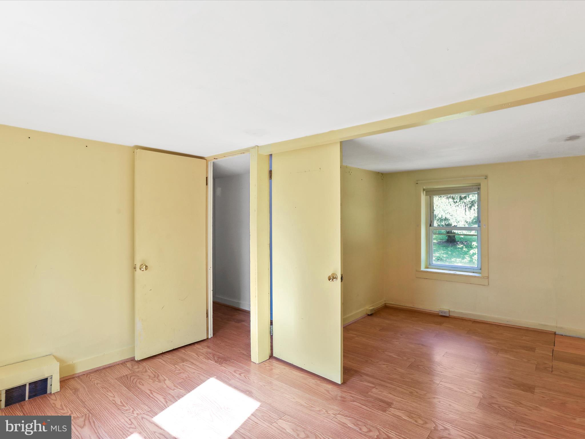 11856 Nicholson Road Keymar, MD 21757 - Photo 17 of 31 a view of an empty room with wooden floor and a window