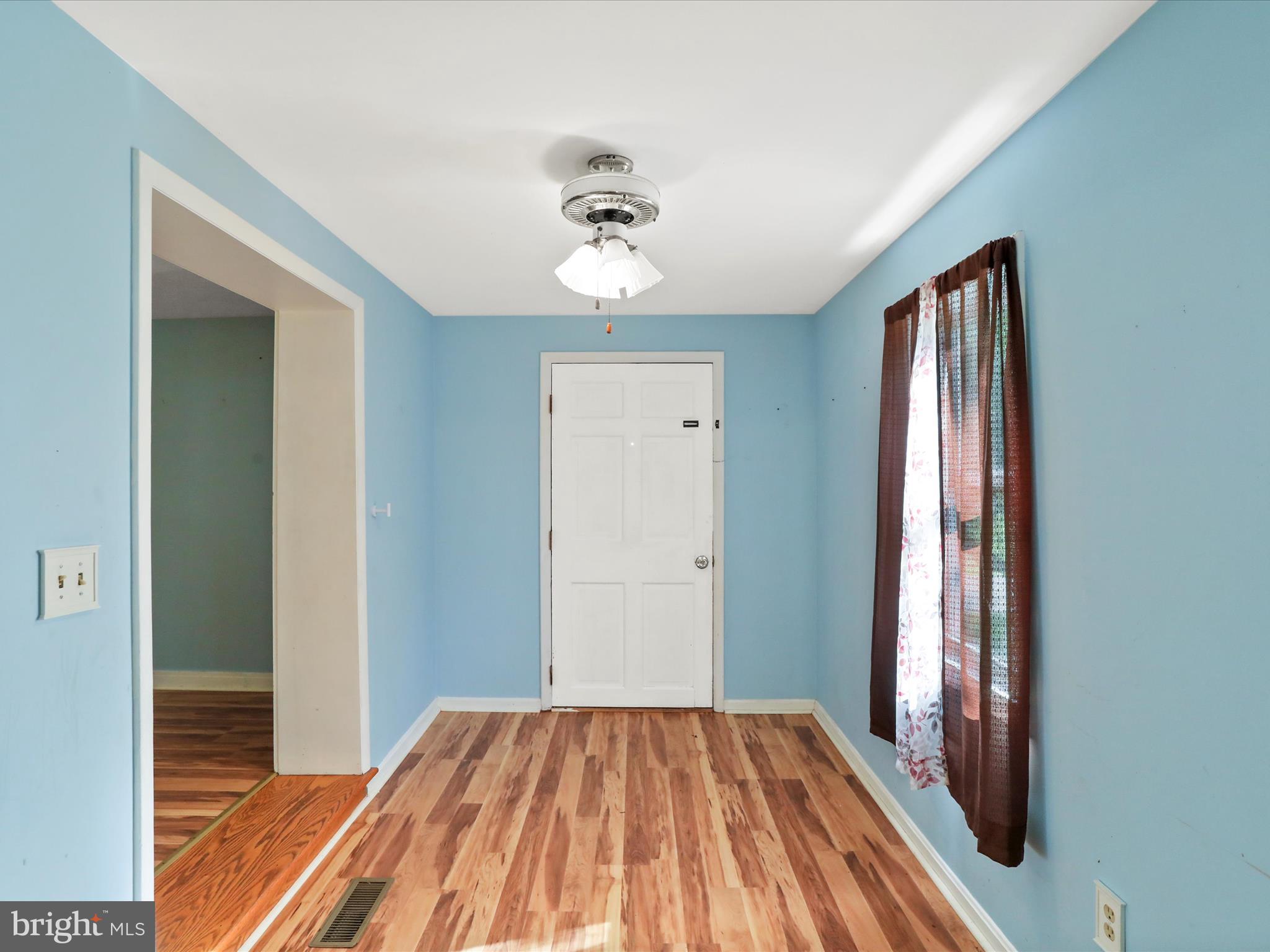 11856 Nicholson Road Keymar, MD 21757 - Photo 4 of 31 a view of a room with wooden floor and ceiling fan