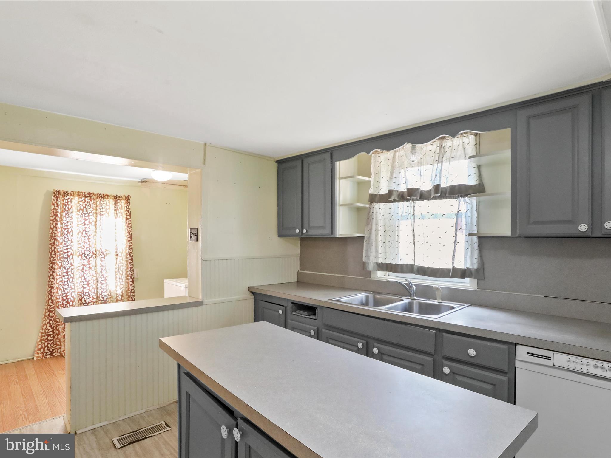 11856 Nicholson Road Keymar, MD 21757 - Photo 10 of 31 a kitchen with a sink window and cabinets