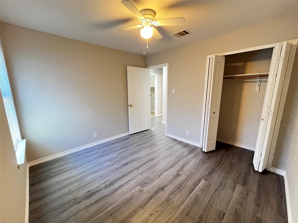 206 Presidio Drive Leander, TX 78641 - Photo 8 of 14 an empty room with wooden floor and a ceiling fan