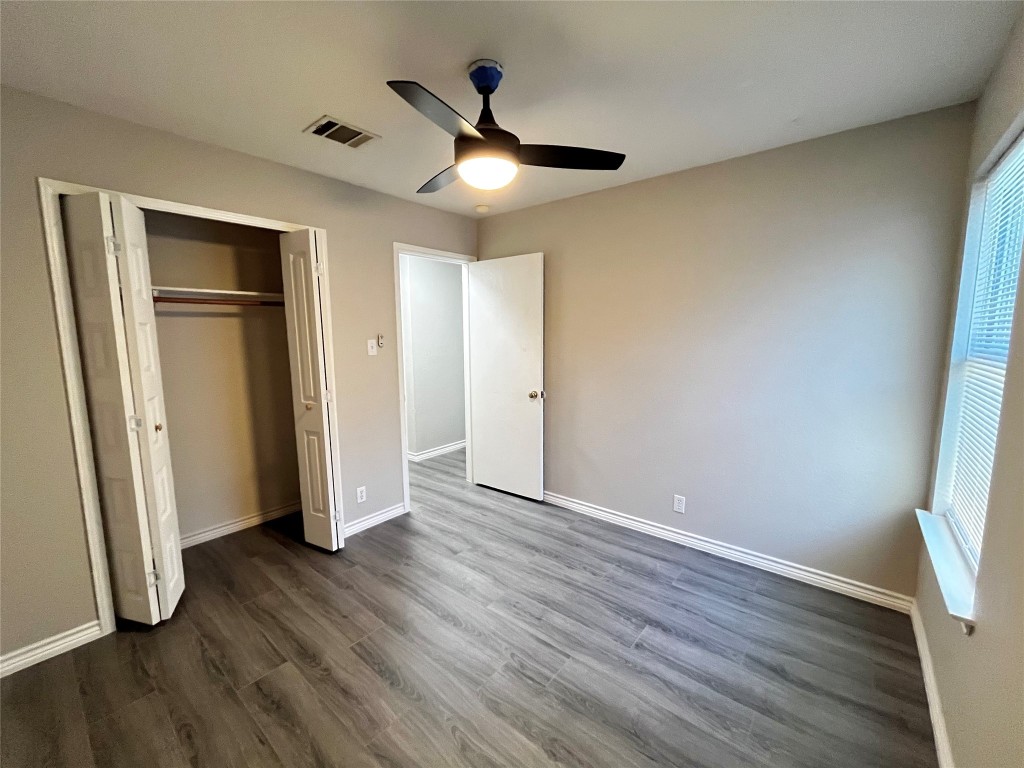 206 Presidio Drive Leander, TX 78641 - Photo 9 of 14 an empty room with wooden floor and a ceiling fan