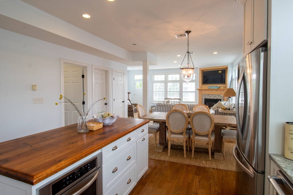 117 River Street Scituate, MA 02050 - Photo 7 of 23 a room with stainless steel appliances kitchen island granite countertop a stove a sink and a refrigerator