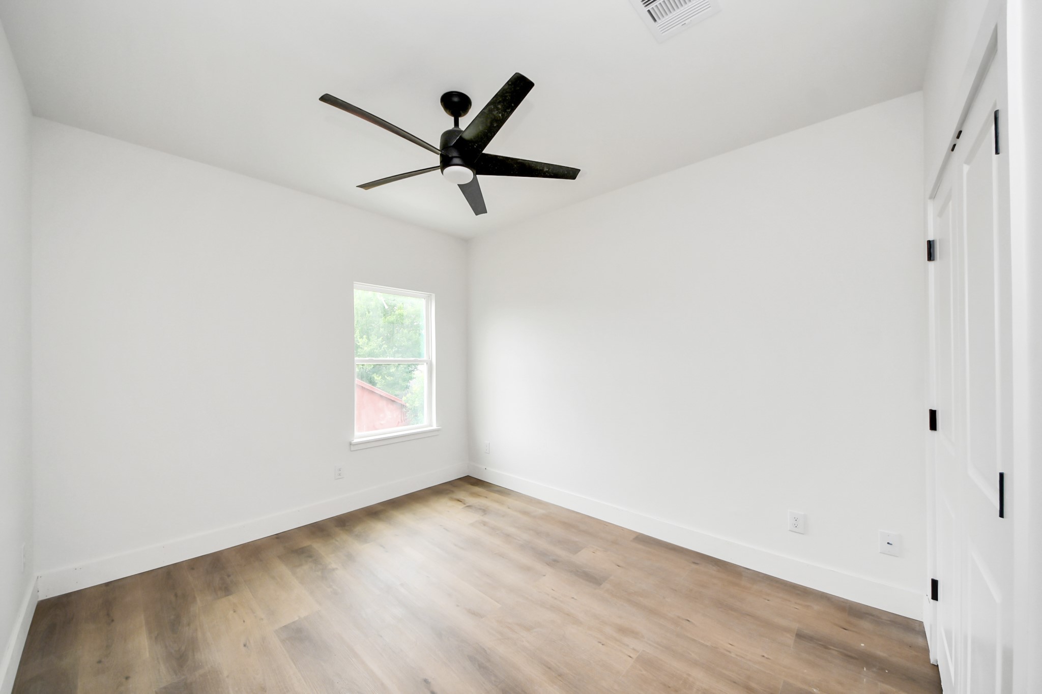 8206 Colonial Lane Houston, TX 77051 - Photo 22 of 31 a view of empty room with wooden floor and fan