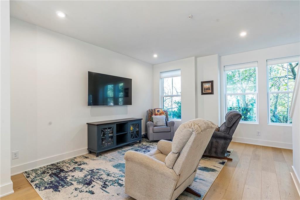230 New Street, Unit 1201 Decatur, GA 30030 - Photo 12 of 29 a living room with furniture a flat screen tv and a fireplace