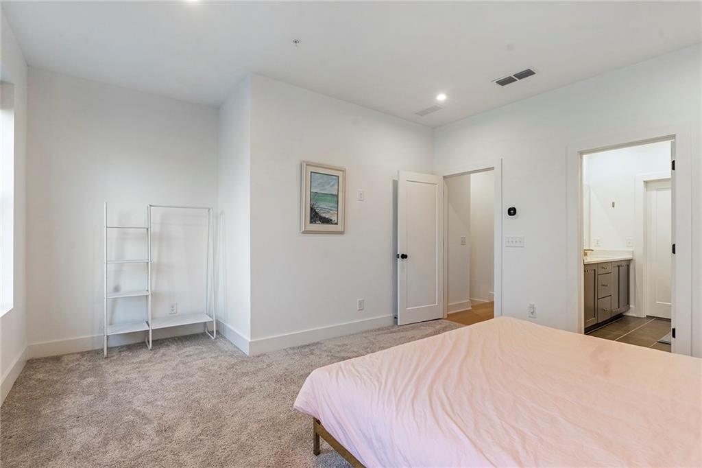 230 New Street, Unit 1201 Decatur, GA 30030 - Photo 19 of 29 a bedroom with a bed and a bathroom