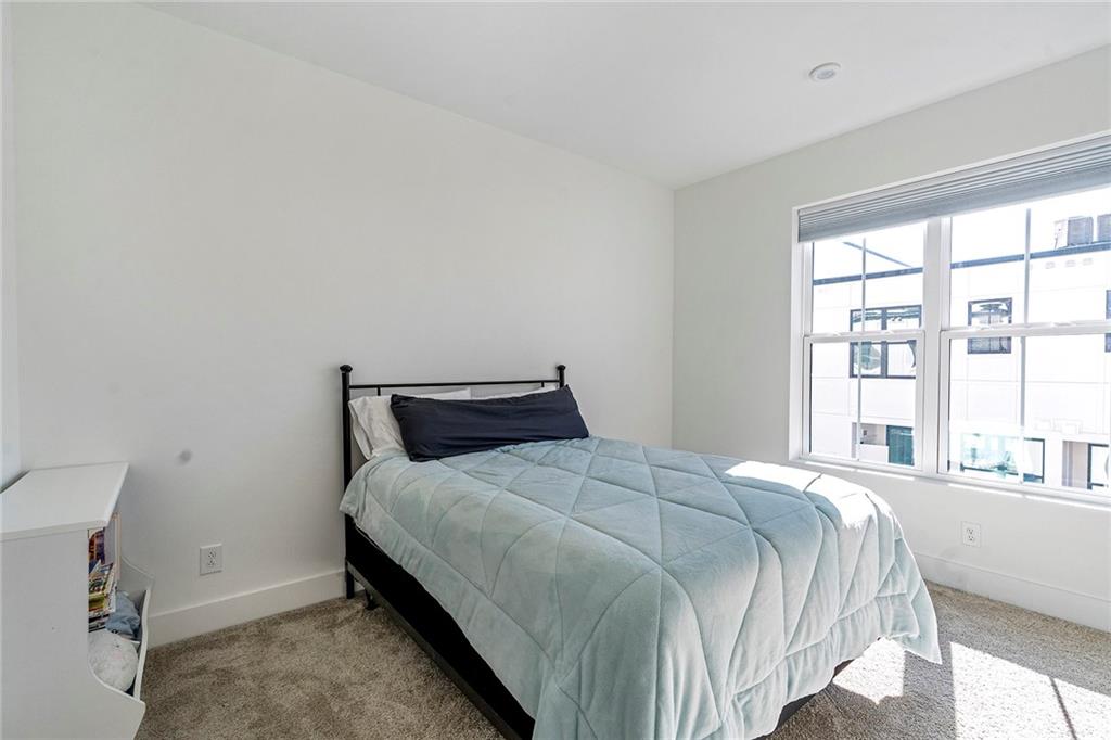 230 New Street, Unit 1201 Decatur, GA 30030 - Photo 23 of 29 a bedroom with a bed and a large window