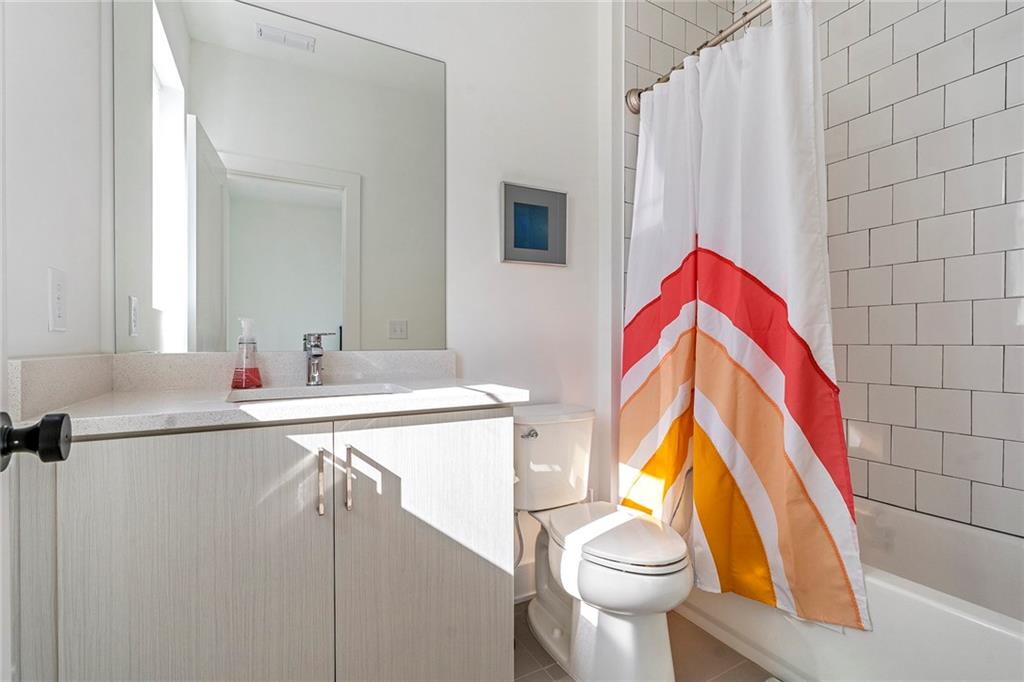 230 New Street, Unit 1201 Decatur, GA 30030 - Photo 25 of 29 a bathroom with a sink a toilet and a mirror