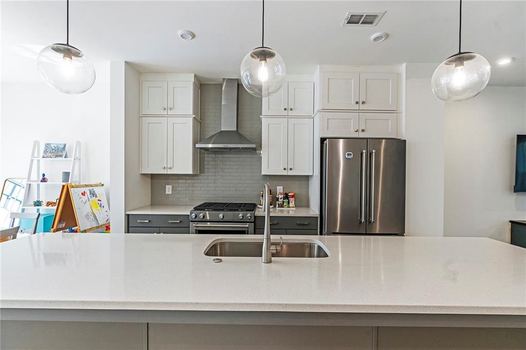 230 New Street, Unit 1201 Decatur, GA 30030 - Photo 9 of 29 a kitchen with stainless steel appliances granite countertop a sink a refrigerator and a white cabinets
