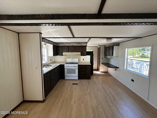 a kitchen with stainless steel appliances granite countertop a sink a stove and a refrigerator