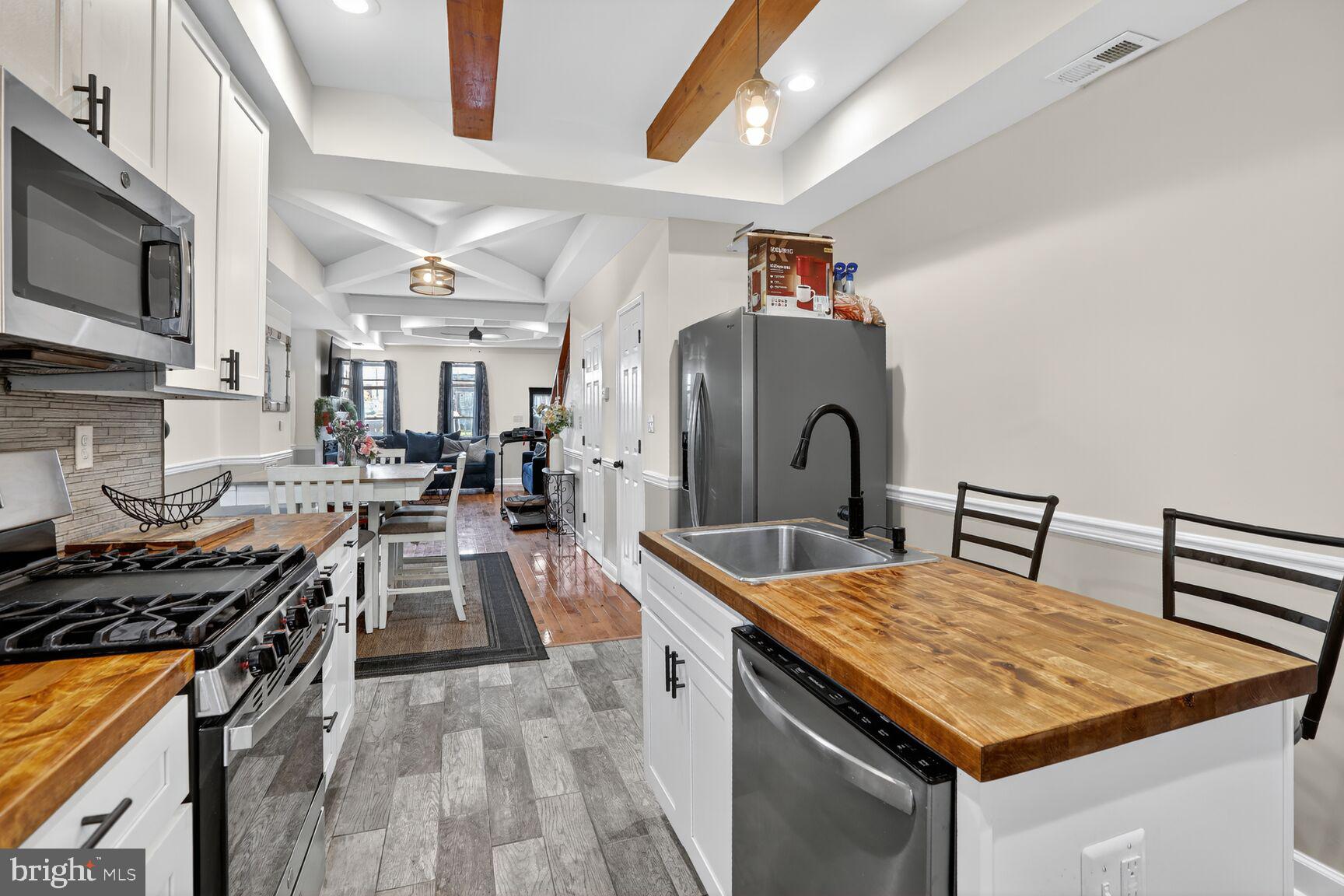 1502 East Hoffman Street Baltimore, MD 21213 - Photo 11 of 30 a kitchen with stainless steel appliances granite countertop a stove and a sink