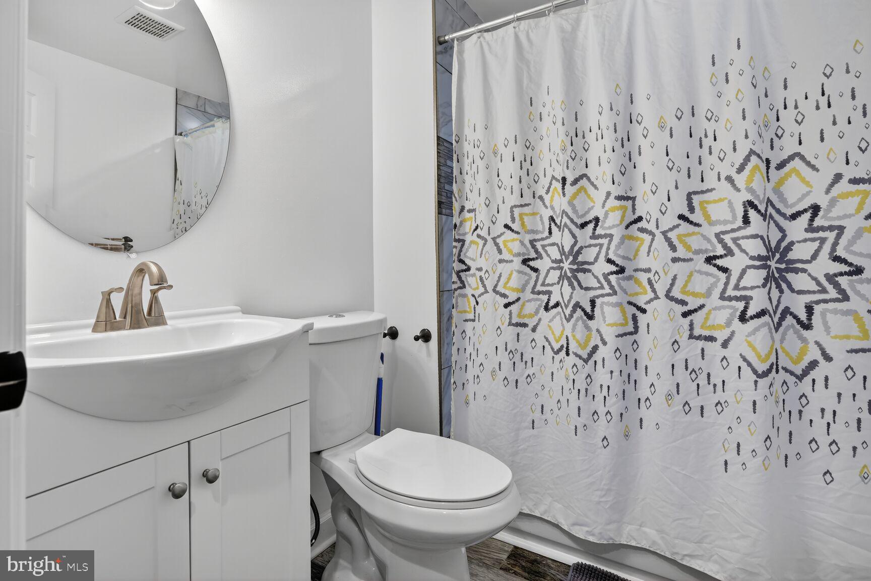 1502 East Hoffman Street Baltimore, MD 21213 - Photo 21 of 30 a bathroom with a sink and toilet