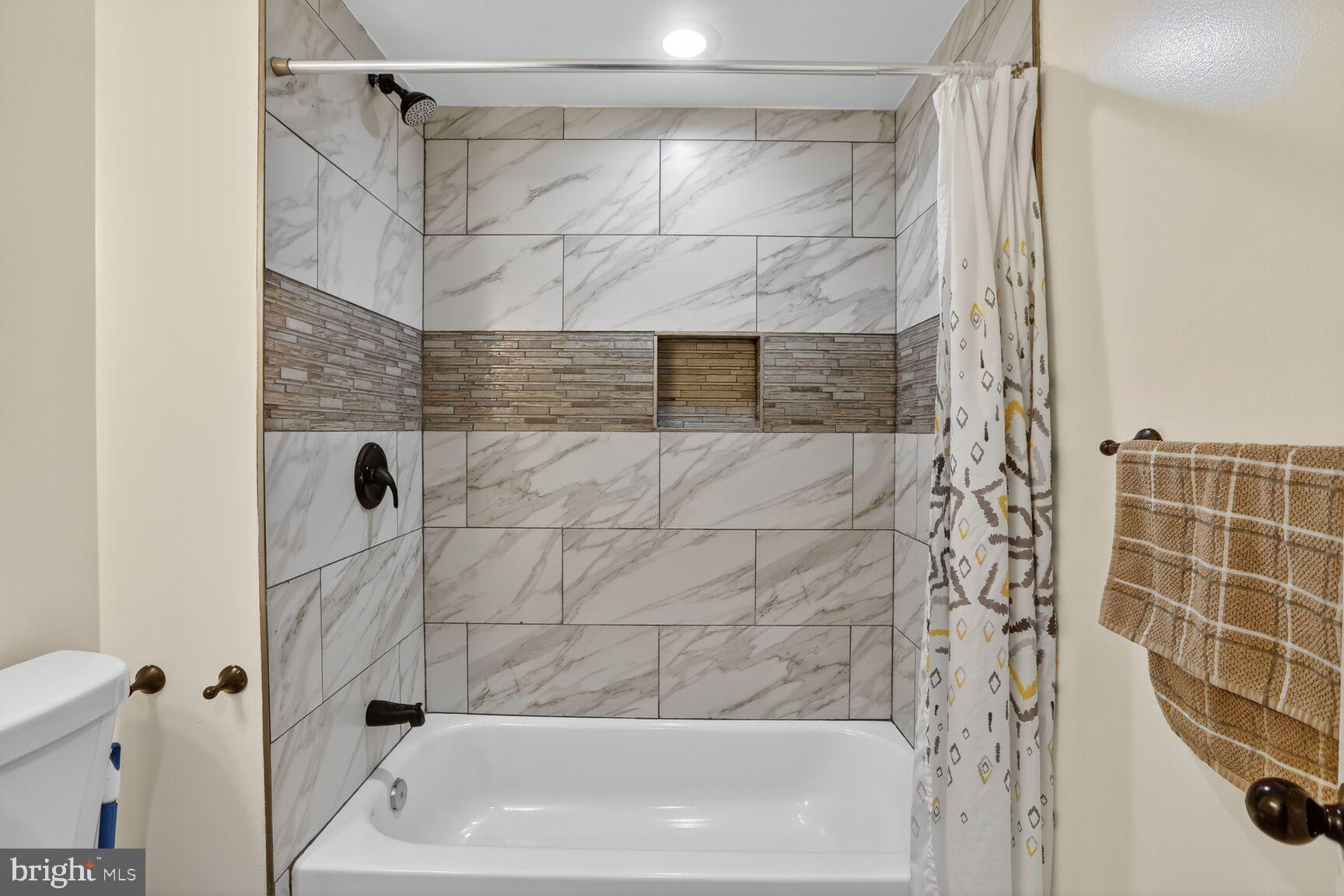 1502 East Hoffman Street Baltimore, MD 21213 - Photo 24 of 30 a bathroom with a shower and a toilet