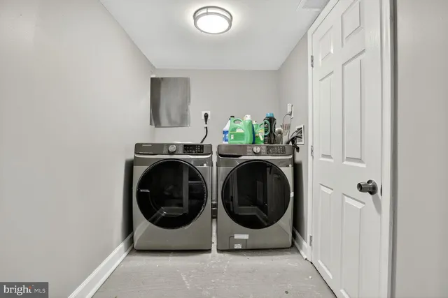 a utility room with sink dryer and washer