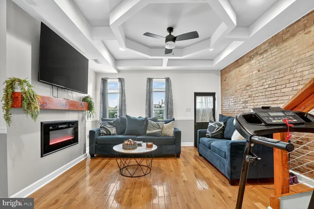 a living room with fireplace furniture and a flat screen tv