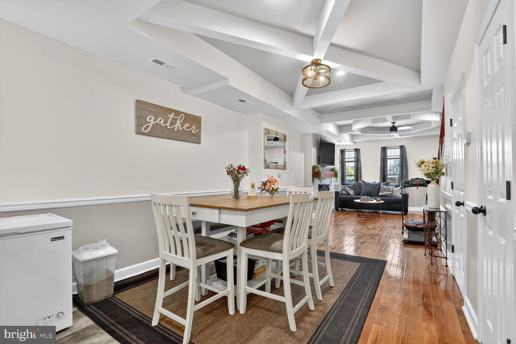 1502 East Hoffman Street Baltimore, MD 21213 - Photo 7 of 30 a view of a dining room with furniture a chandelier and wooden floor