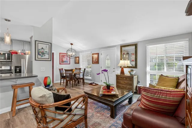 a kitchen with stainless steel appliances granite countertop a dining table and chairs