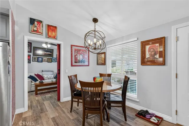 a view of a dining room with furniture and a chandelier