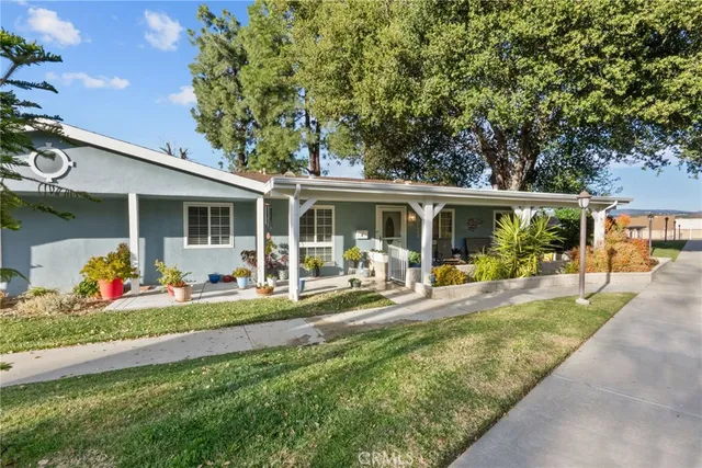 a house view with a sitting space and garden space