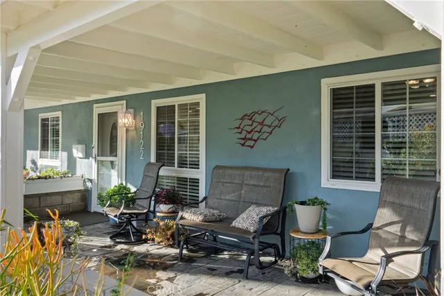 a building outdoor space with patio furniture and potted plants