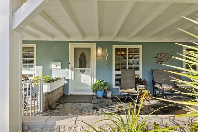 a living room filled with furniture and a kitchen view