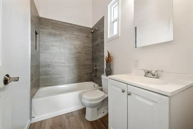 a bathroom with a sink toilet and shower