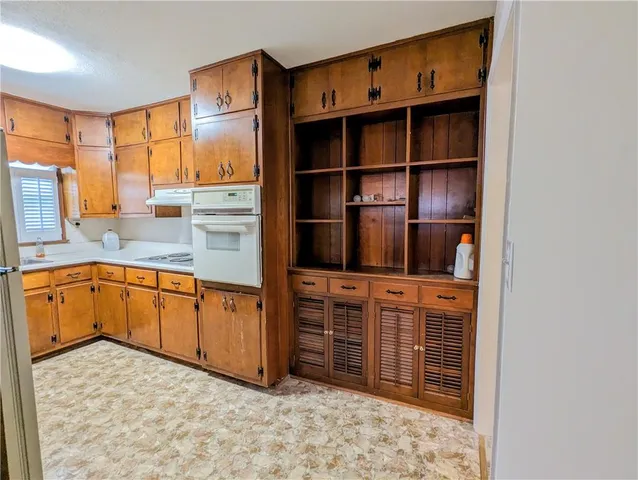 a kitchen with stainless steel appliances a cabinets and window