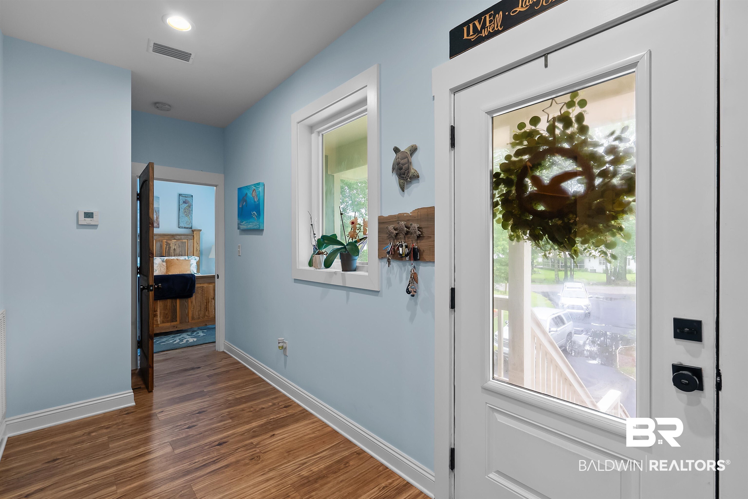 7266 Franklin Road Foley, AL 36535 - Photo 22 of 64 Entryway featuring wood-finish flooring, light blue wall paint, and white trim