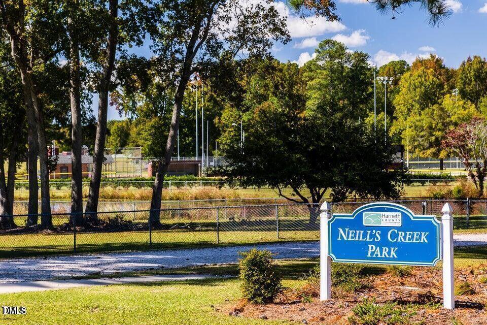 44 Charlie Circle Angier, NC 27501 - Photo 32 of 48 a view of a sign board with large trees