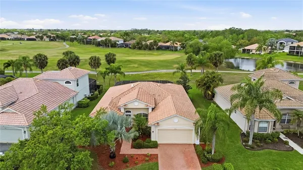 an aerial view of a house with garden space and lake view