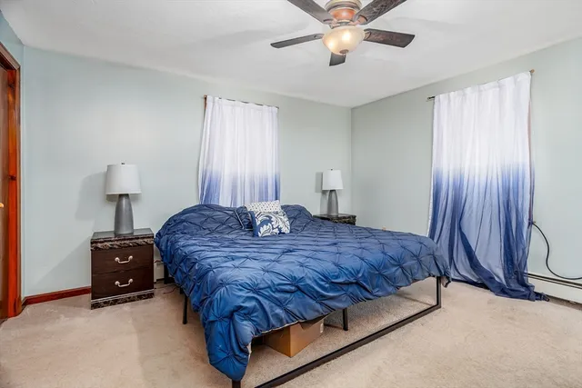 a spacious bedroom with a bed and a chandelier
