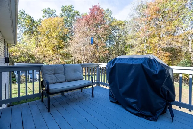 a view of a deck with furniture and trees