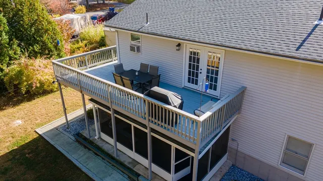 a front view of house with yard and trees in the background