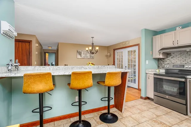 a kitchen with stainless steel appliances granite countertop a refrigerator and a stove top oven
