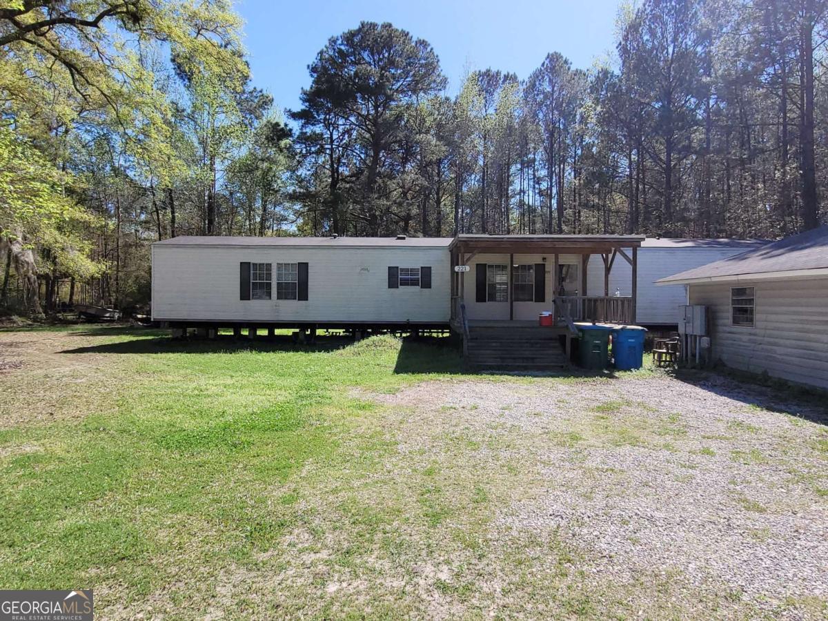 219 John Carter Road Bloomingdale, GA 31302 - Photo 15 of 28 a front view of a house with a yard and trees