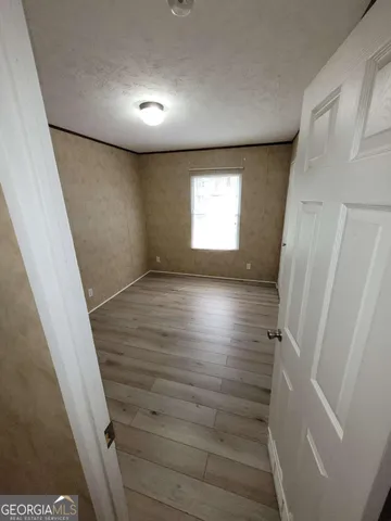 a view of hallway with stairs and wooden floor
