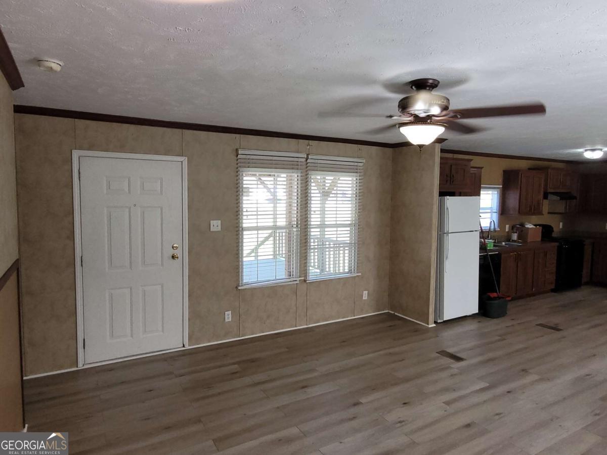 219 John Carter Road Bloomingdale, GA 31302 - Photo 19 of 28 a view of a livingroom with a ceiling fan window and wooden floor