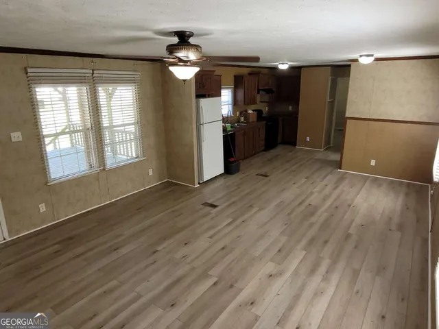a view of a kitchen with a sink and refrigerator
