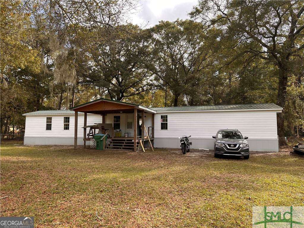 219 John Carter Road Bloomingdale, GA 31302 - Photo 2 of 28 a car parked in front of a house