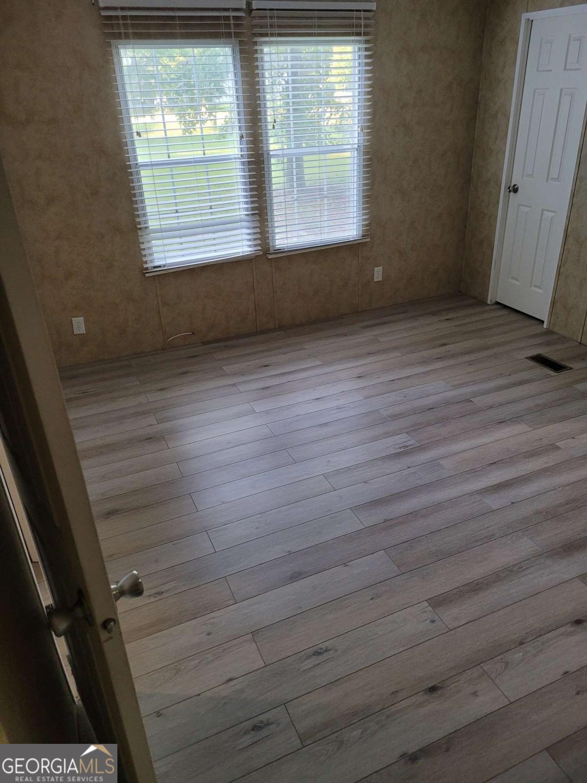 219 John Carter Road Bloomingdale, GA 31302 - Photo 21 of 28 a view of an empty room with wooden floor and a window