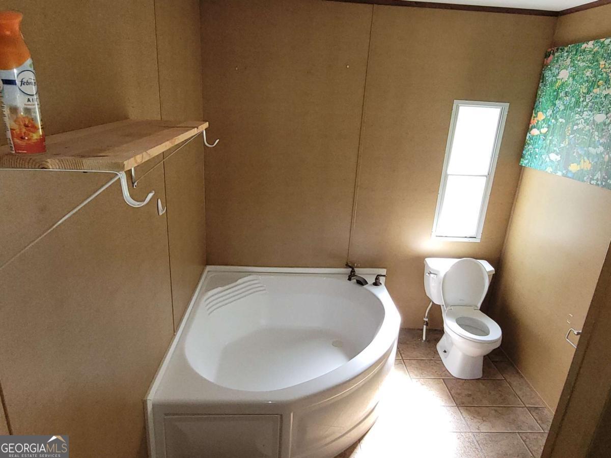 219 John Carter Road Bloomingdale, GA 31302 - Photo 22 of 28 a bathroom with a toilet and a window