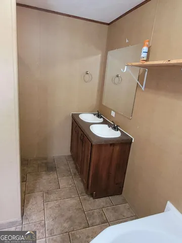 a bathroom with a sink a vanity and a mirror