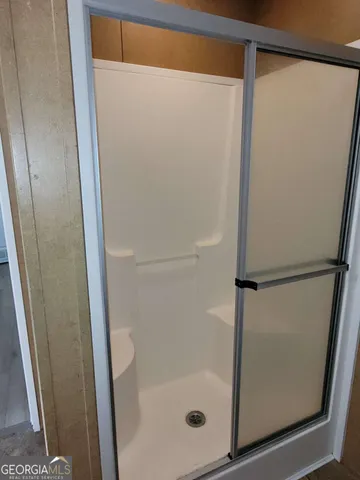 a bathroom with a glass shower door