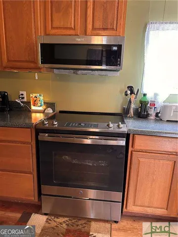 a kitchen with granite countertop cabinets and steel stainless steel appliances